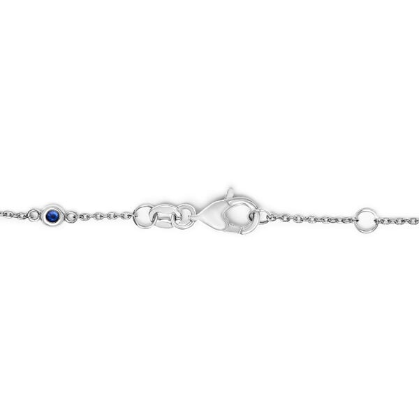 Close view of bezel-set sapphire and diamond stations on a white gold chain bracelet