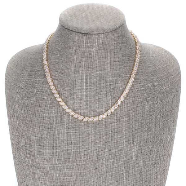 Close-up of trillion-cut cubic zirconia stones set in a goldtone finish plated over gold tone setting