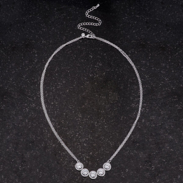 Rhodium plated over lead free alloy (brass) classic necklace with round cubic zirconia.