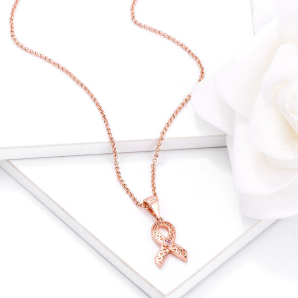 Pink round cubic zirconia heart filigree breast cancer awareness ribbon pendant with a 1.5mm stone size.
