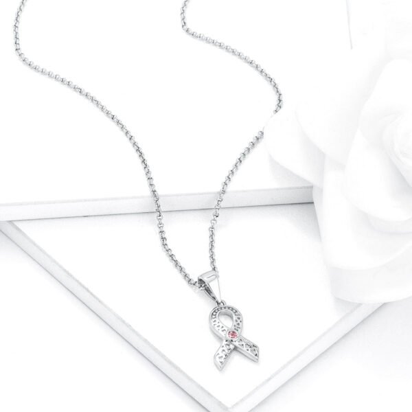Pink round cubic zirconia heart filigree breast cancer awareness ribbon pendant in silver tone over lead free alloy (brass).