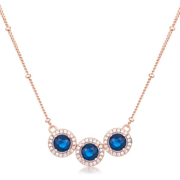 Tri-halo pendant in rose gold tone over brass with blue sapphire-colored cubic zirconia and clear cubic zirconia
