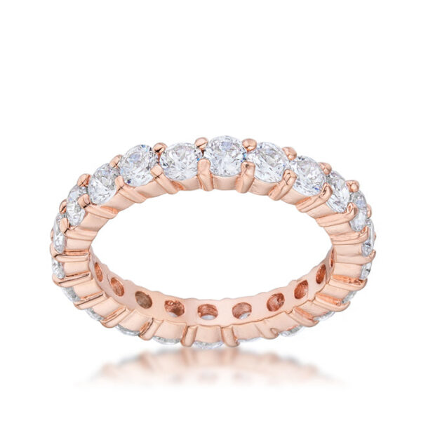 Rose gold tone finish over lead free alloy (brass) band ring with round cubic zirconia in prongs.