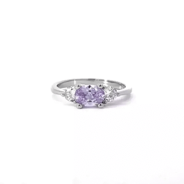 Rhodium plated over lead free alloy (brass) classic ring with lavender oval cubic zirconia in prongs.