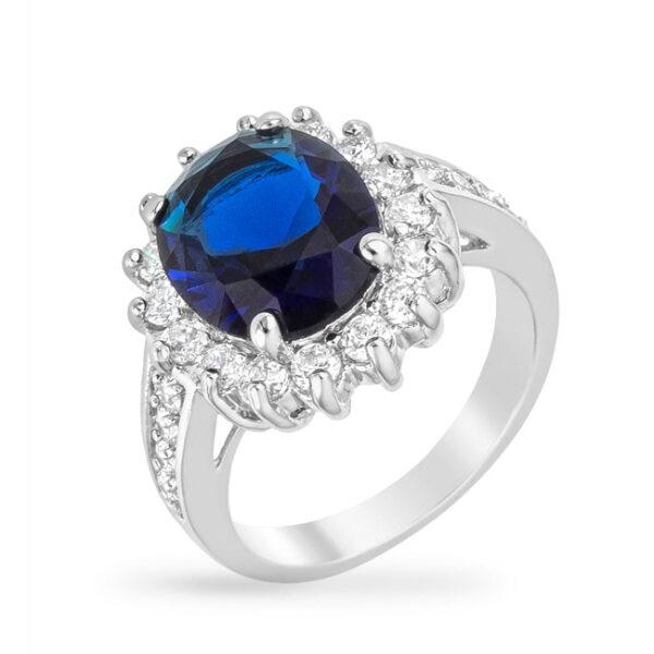 Blue ring with oval crystal, cubic zirconia, sapphire, prong setting, and rhodium plated over lead free alloy (brass).