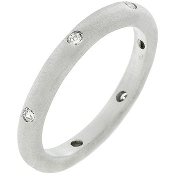 Contemporary wedding band in silver tone matte finish over lead free alloy (brass) with round genuine cubic zirconia in bezel settings.