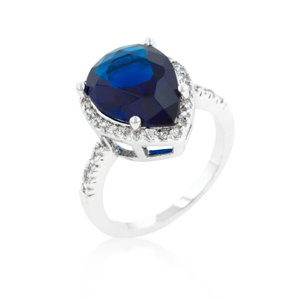 Drop ring with round sapphire-colored cubic zirconia in prong settings and rhodium plated over lead free alloy (brass).