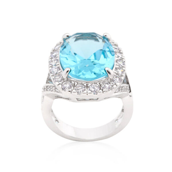 Blue topaz-colored cubic zirconia cocktail ring with 15 ct total stone weight, rhodium plated over lead free alloy (brass).
