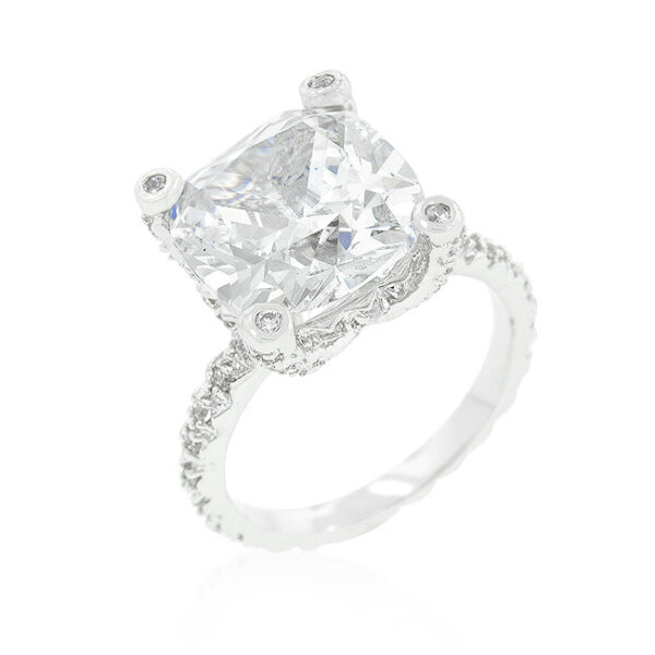 Cushion cubic zirconia ring in prongs with 7.2 ct total stone weight and a rhodium plated over lead free alloy (brass) band