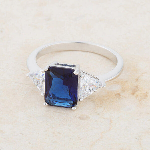 Classic bridal ring with a 9mm trillion-cut genuine sapphire-colored cubic zirconia, 4.5 ct total stone weight, and 2.2mm width.