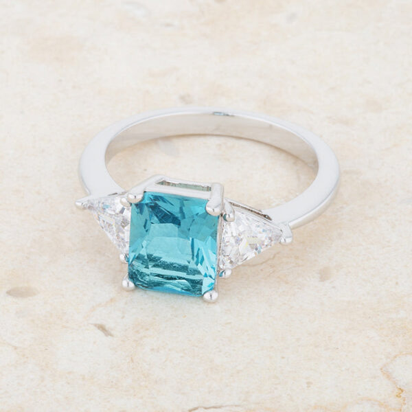 Classic bridal ring with blue topaz-colored cubic zirconia in prongs and rhodium plated over lead free alloy (brass).