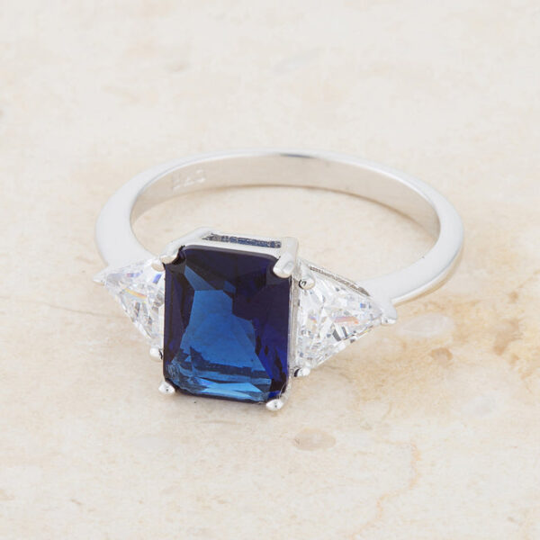 2.2mm wide ring with radiant-cut sapphire-colored cubic zirconia in a prong setting.