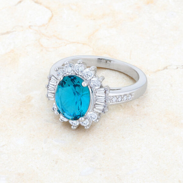 Rhodium plated over lead free alloy (brass) classic ring with aqua cubic zirconia and 3 ct total stone weight.