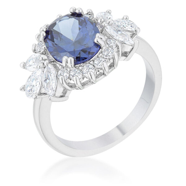 Classic ring with round tanzanite-colored cubic zirconia in prongs and a rhodium plated over lead free alloy (brass) band.