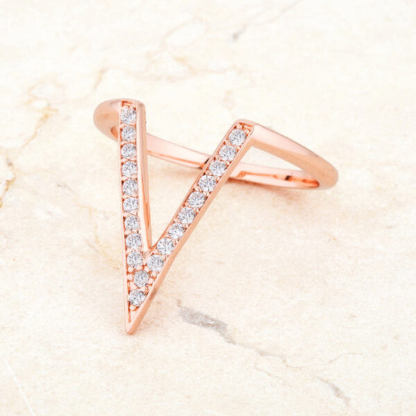 Round 1.3 Mm cubic zirconia in prongs on a rosegold plated over lead free alloy (brass) V-shape ring.