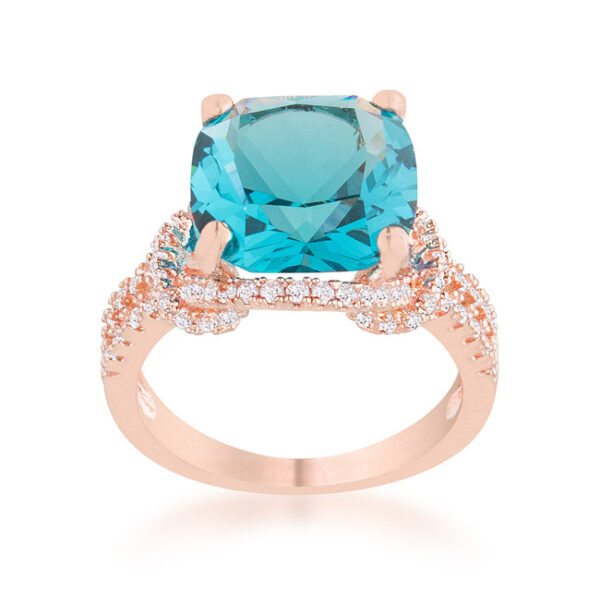 Aqua cubic zirconia statement ring with cushion and round cuts in prongs and a rose gold tone over lead free alloy (brass) finish.