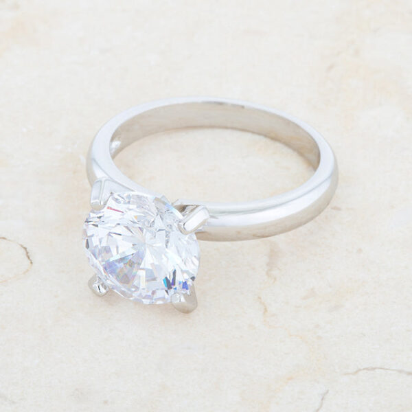 Round cubic zirconia held in prongs on a rhodium plated over lead free alloy (brass) solitaire ring.