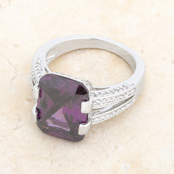 Classic cocktail ring in rhodium plated over lead free alloy (brass) with -cut amethyst-colored cubic zirconia.