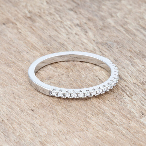 Rhodium plated over lead free alloy (brass) band ring with round-cut cubic zirconia in a channel setting.