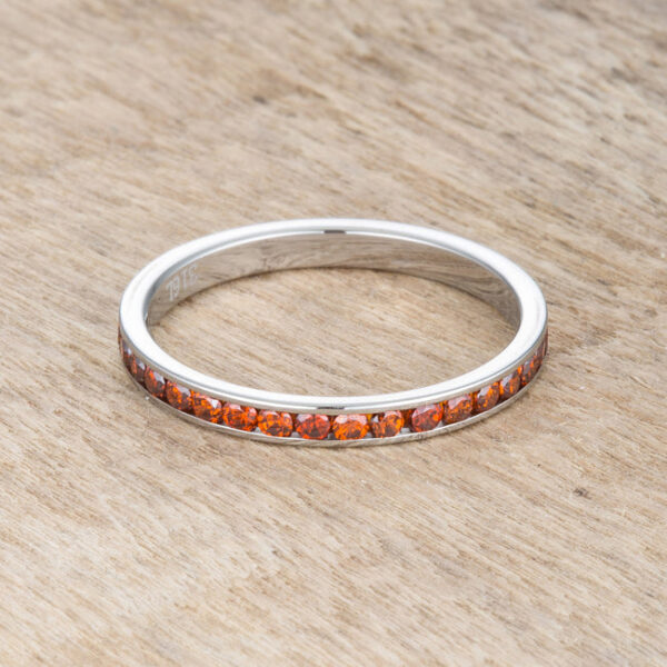 Round dark champagne cubic zirconia in a channel setting on a silver tone over stainless steel eternity band.