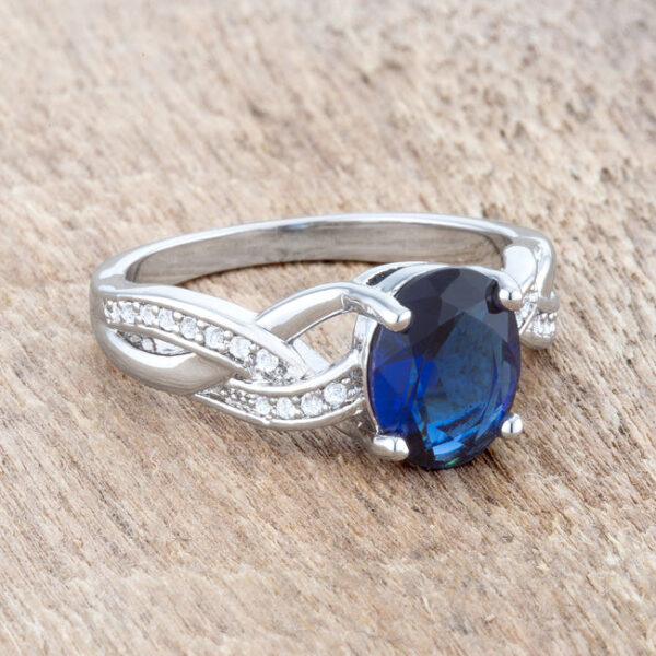 Classic oval ring in rhodium plated over lead free alloy (brass) with round sapphire-colored cubic zirconia.