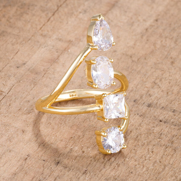 Side angle of the goldtone ring showing the open band and stone settings from a different perspective