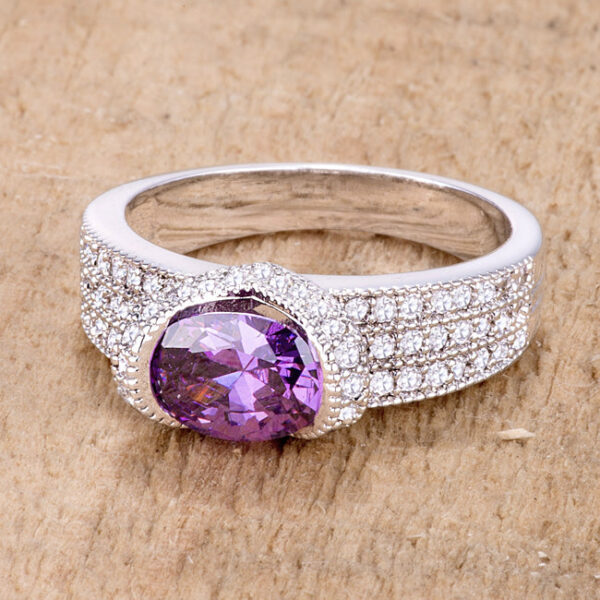 Classic oval ring in rhodium plated over lead free alloy (brass) with amethyst-colored cubic zirconia in a prong setting.