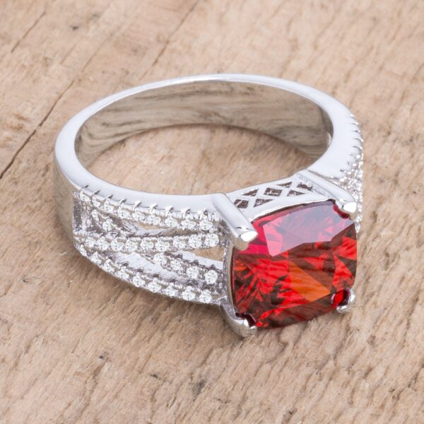 Garnet-colored cubic zirconia criss-cross ring with cushion and round cuts in a prong setting.