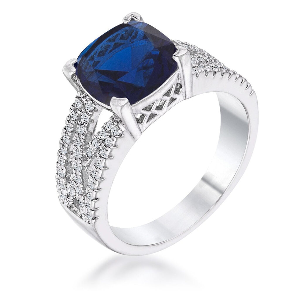 Silvertone criss-cross ring with sapphire-colored cubic zirconia in cushion and round cuts held in prong settings