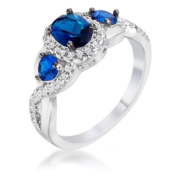 Sapphire blue and clear cubic zirconia three-stone twisted ring in silver tone over lead free alloy (brass).