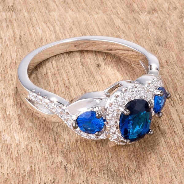 Twisted three-stone ring with blue and clear cubic zirconia in silver tone over lead free alloy (brass).