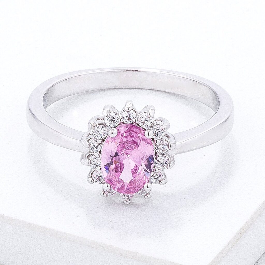 Pink oval cubic zirconia ring in a prong setting with a silver tone over brass finish.