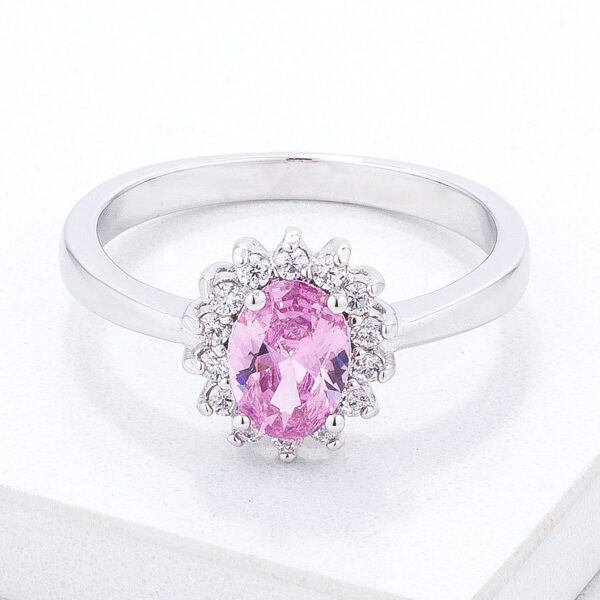 Pink oval cubic zirconia ring in a prong setting with a silver tone over brass finish.
