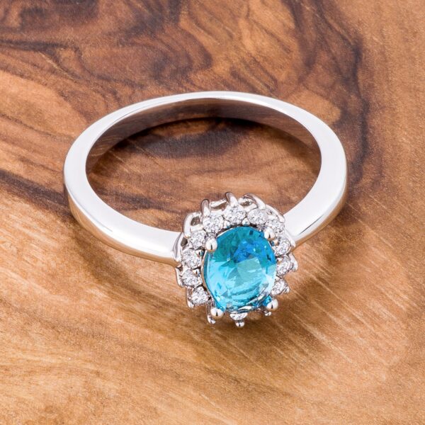 Classic ring with blue oval cubic zirconia in a prong setting and a silver tone over brass finish.