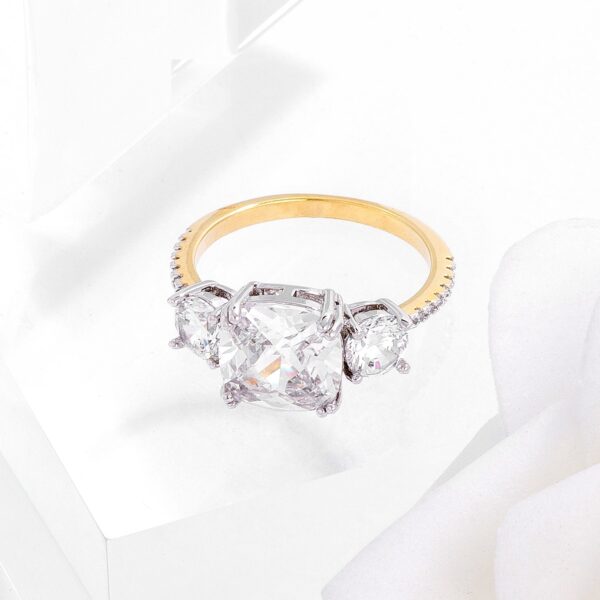 Classic engagement-style ring with cushion- and round-cut cubic zirconia in prong settings and a tu tone finish.