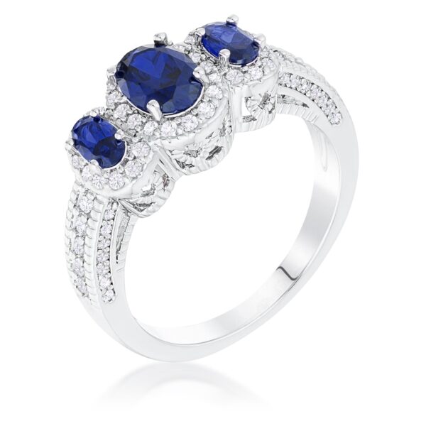 Silver tone over brass halo ring with 3 sapphire-colored cubic zirconia stones in an oval-cut design.