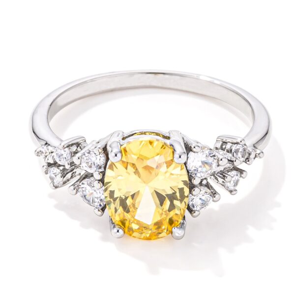 Yellow oval cubic zirconia engagement ring with 2.95 ct total weight, rhodium finish plated over lead free alloy (brass).