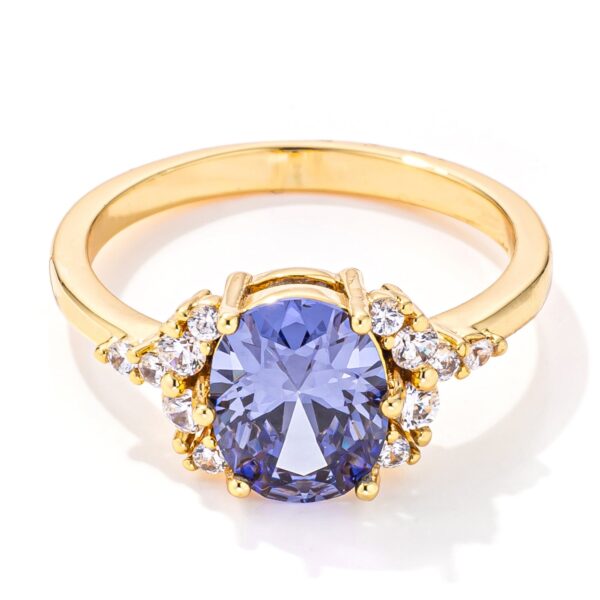 Oval tanzanite and cubic zirconia engagement ring in gold tone over lead free alloy (brass).