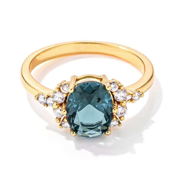 Oval blue and green cubic zirconia engagement ring in gold tone over lead free alloy (brass).
