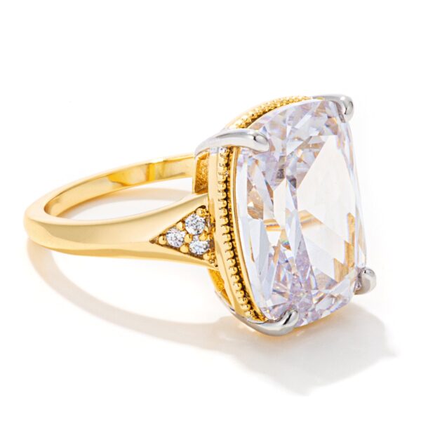 Engagement ring with a gold tone finish and an elongated cushion cut detail.
