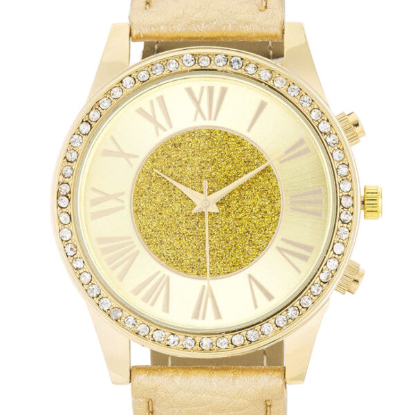 Close view of the watch case showing goldtone plating and clear crystals around the dial