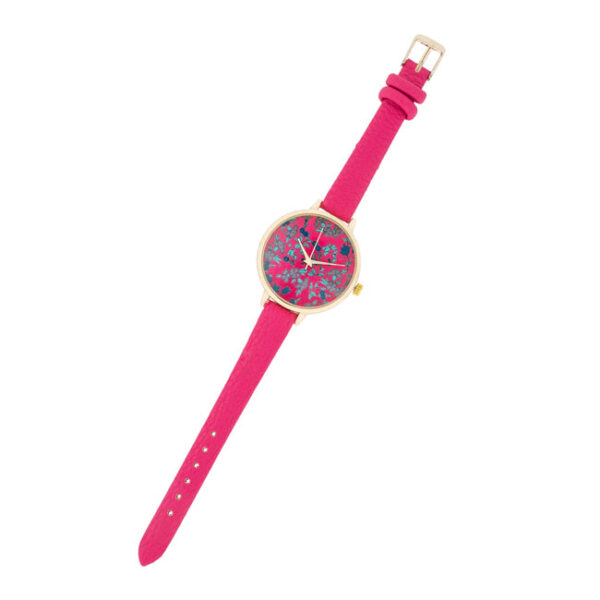 Close angle of the gold plated watch case showing the floral dial detail