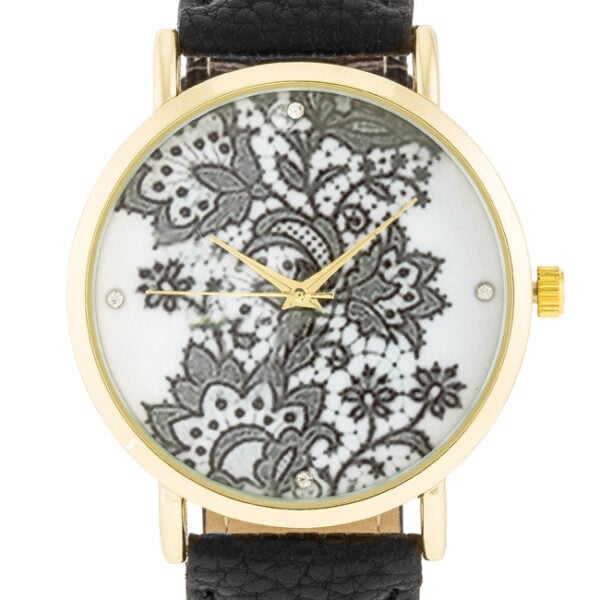 Close angle of the gold-tone watch face showing crystal placement around the floral dial