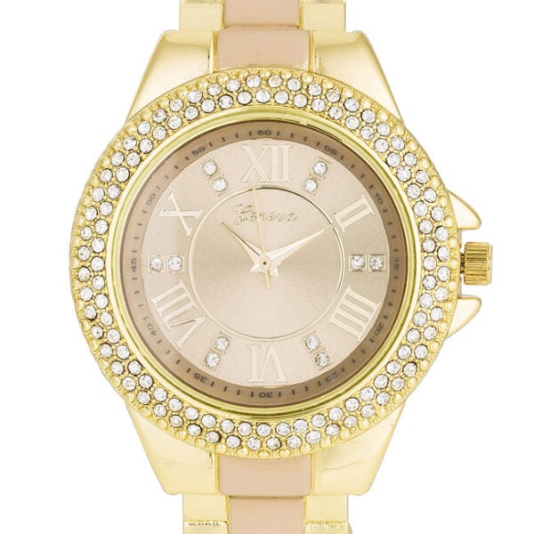 Close-up of the beige watch face surrounded by crystals on the gold metal cuff watch