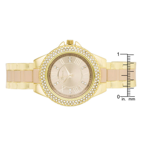 Side angle of the gold metal cuff watch showing the open band edge and its beige-toned finish