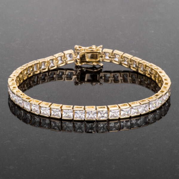 Bracelet clasp area showing the lock clasp mechanism against the goldtone plated band