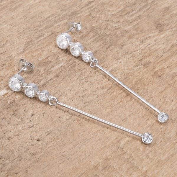 Angled view of the drop earrings showing the rhodium plated finish catching light across the stones