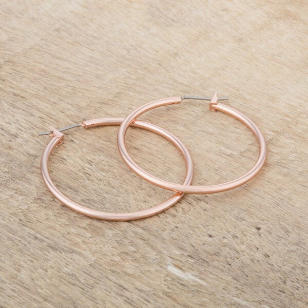 Rose gold hoop earrings shown together, highlighting their matching round shape