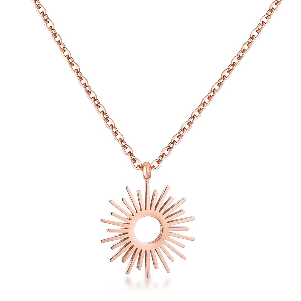 Rose gold plated sunburst pendant necklace on a plain background