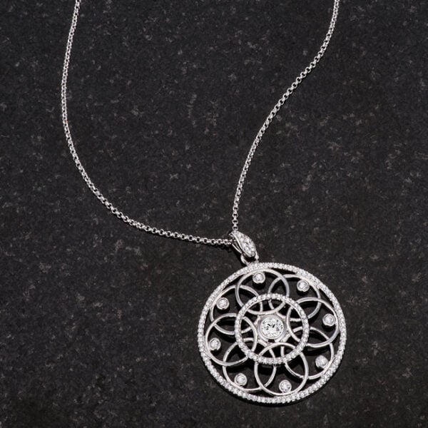 Rhodium plated pendant necklace displayed at an angle to show its dimension and finish